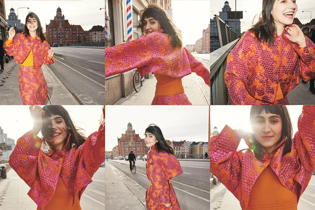 Laleh i orange och rosa kläder poserar och ler energiskt på en stadsgata med historiska byggnader i bakgrunden, från flera vinklar och närbilder i ett collage av sex foton.