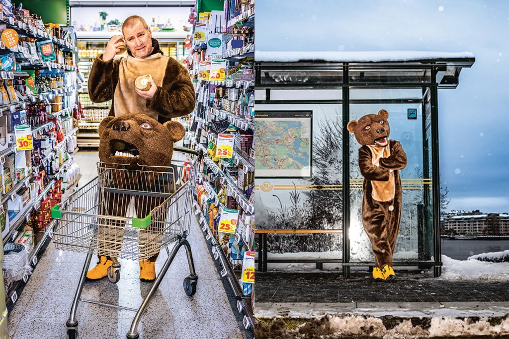 Magnus Krepper i björndräkt handlar i en livsmedelsbutik med björnhuvudet i armen; i en annan scen står han vid en snöig busshållplats iförd hela björndräkten med armarna i kors.